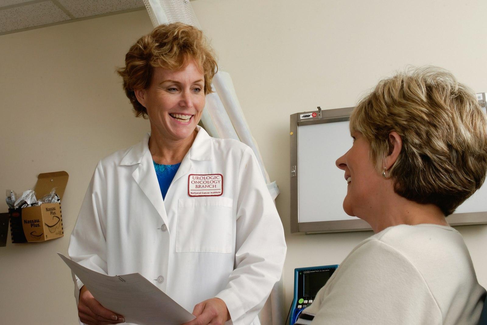 Senior compliance director reviewing customized safety binders with a practice manager in Regional Healthcare Facilities